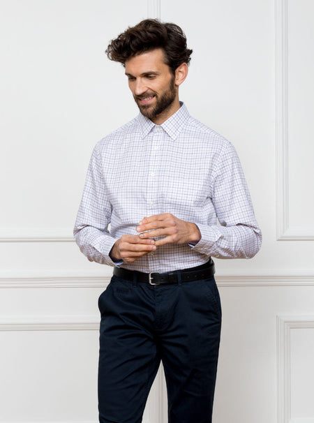 Man wearing long sleeved shirt in a tattersall blue check pattern design with premium and luxury cotton in Thomas Mason fabric.